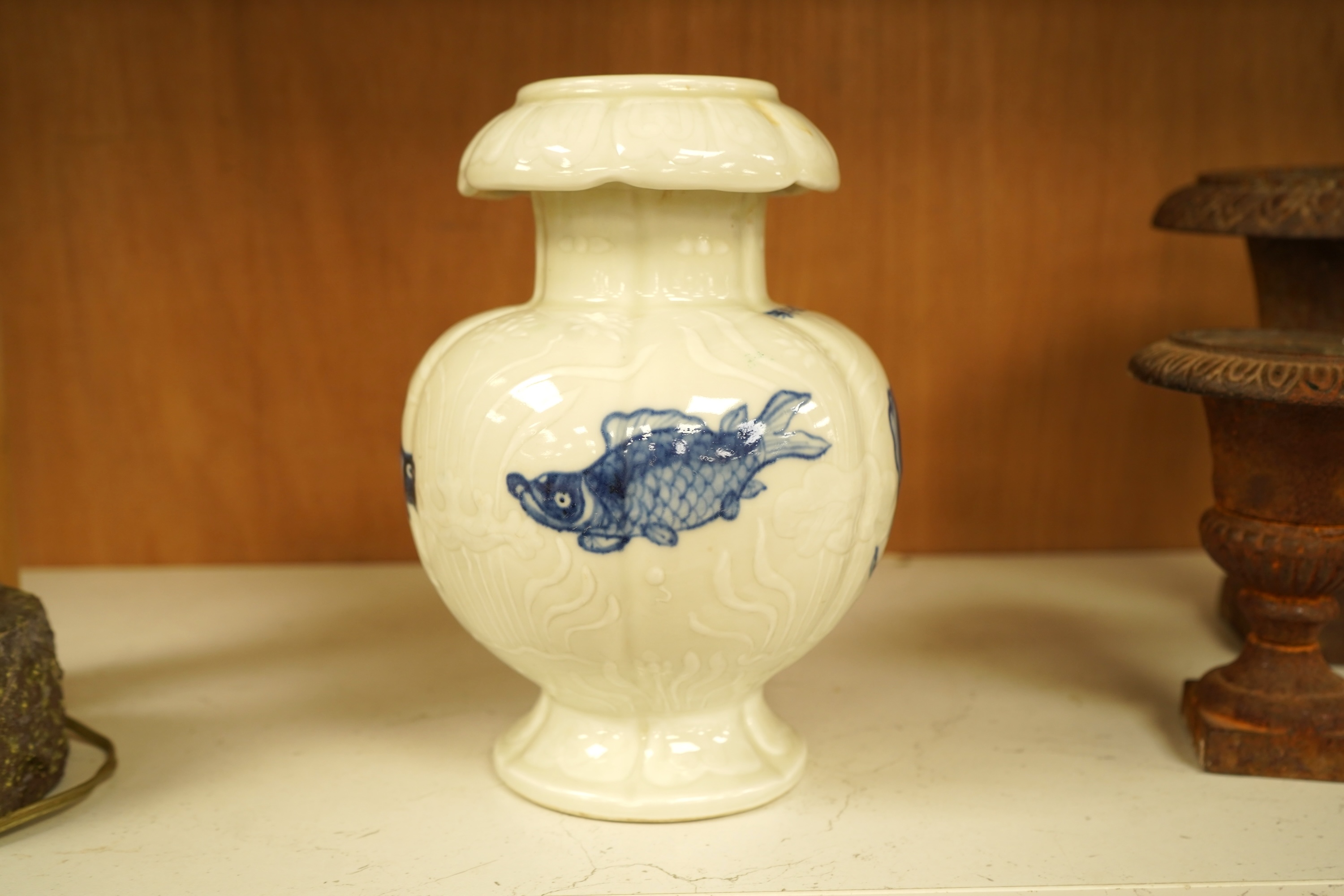 A Chinese vase decorated in low relief, hand painted with fish, 20cm high